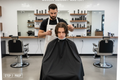 A person preparing their head for a haircut in a clean barbershop setting
